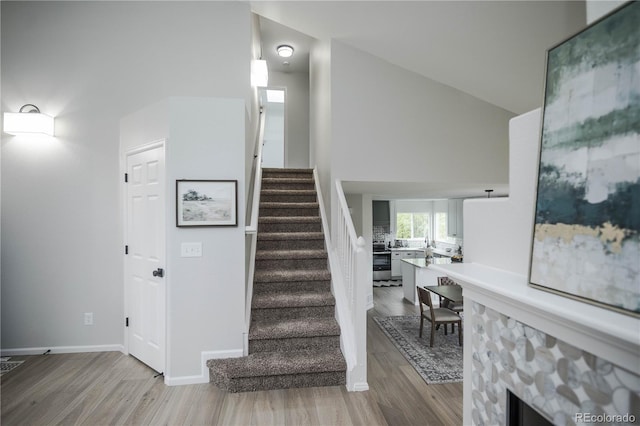 329 Lodgewood Ln, Lafayette, CO 80026 - stairway with wood finished floors, baseboards, and lofted ceiling