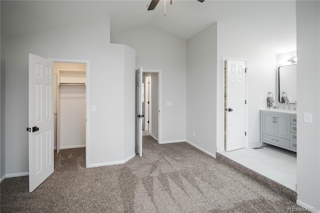 329 Lodgewood Ln, Lafayette, CO 80026 - unfurnished bedroom featuring carpet flooring, a walk in closet, vaulted ceiling, baseboards, and ensuite bathroom