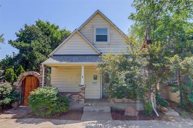 4032 Lipan St, Denver, CO 80211 - bungalow-style house with covered porch, a shingled roof, and brick siding