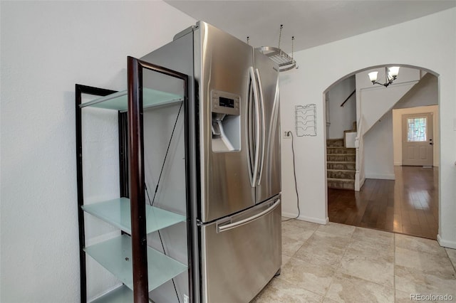 4032 Lipan St, Denver, CO 80211 - kitchen with stainless steel fridge with ice dispenser, arched walkways, and light tile patterned floors