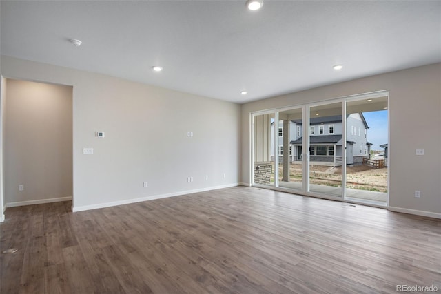 3443 N Gold Bug Ct, Aurora, CO 80019 - spare room featuring baseboards, wood finished floors, and recessed lighting
