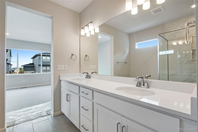 3443 N Gold Bug Ct, Aurora, CO 80019 - bathroom with a sink, a wealth of natural light, and a shower stall