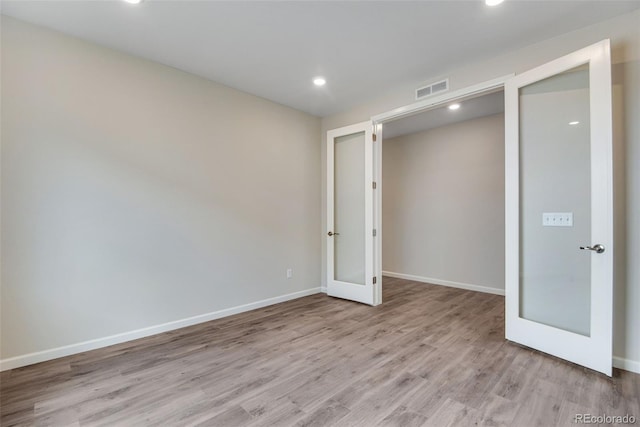 3443 N Gold Bug Ct, Aurora, CO 80019 - empty room with french doors, wood finished floors, baseboards, and visible vents