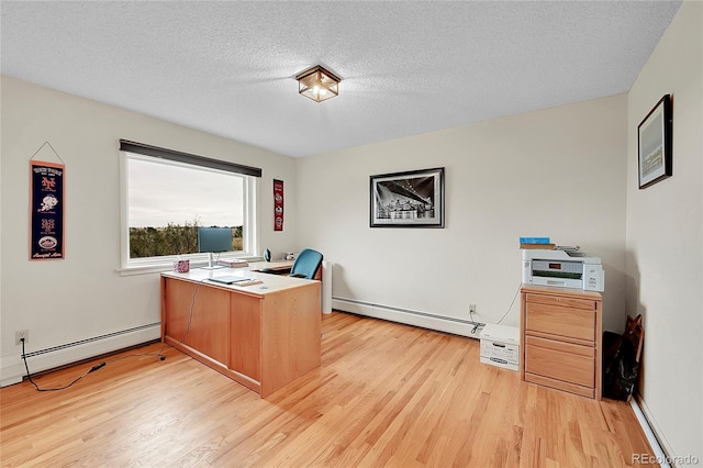 office featuring a baseboard heating unit, light wood finished floors, and a textured ceiling