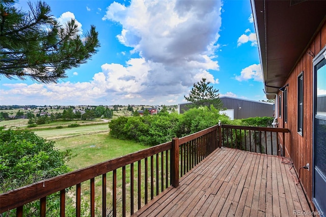 wooden deck featuring a yard