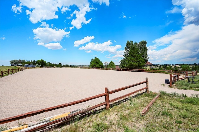 view of yard with a water view, an enclosed area, and a rural view