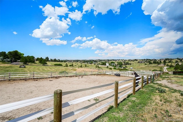 view of yard with an enclosed area and a rural view