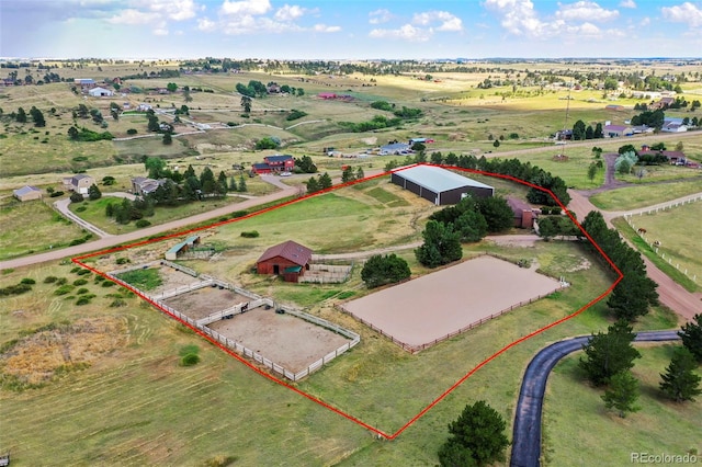birds eye view of property with a rural view