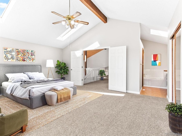 bedroom with high vaulted ceiling, a skylight, carpet flooring, beam ceiling, and ensuite bath