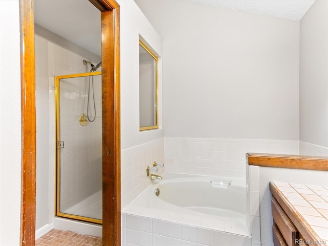 bathroom with a stall shower and a bath