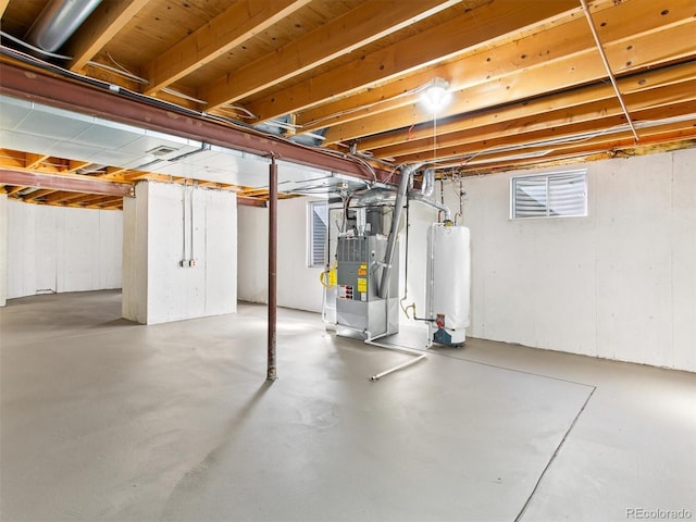 below grade area featuring gas water heater and heating unit