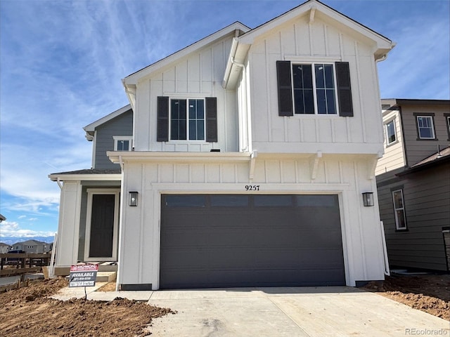 modern inspired farmhouse featuring board and batten siding, driveway, and an attached garage