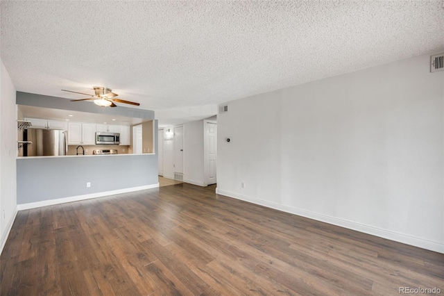 401 S Kalispell Way Unit 206, Aurora, CO 80017 - unfurnished living room with dark wood-type flooring, a textured ceiling, and a ceiling fan