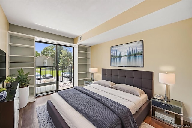 401 S Kalispell Way Unit 206, Aurora, CO 80017 - bedroom with access to exterior and wood finished floors