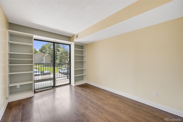 401 S Kalispell Way Unit 206, Aurora, CO 80017 - unfurnished room with dark wood finished floors and a textured ceiling