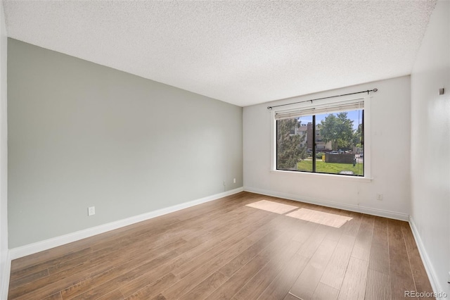 401 S Kalispell Way Unit 206, Aurora, CO 80017 - spare room with wood finished floors and a textured ceiling