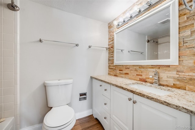 401 S Kalispell Way Unit 206, Aurora, CO 80017 - full bathroom featuring decorative backsplash, vanity, washtub / shower combination, and wood finished floors