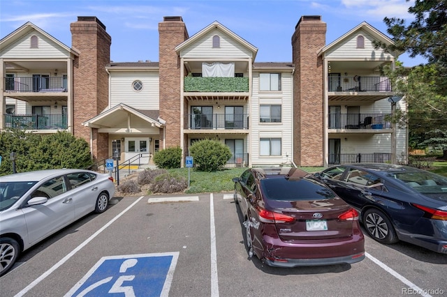 401 S Kalispell Way Unit 206, Aurora, CO 80017 - view of building exterior with uncovered parking