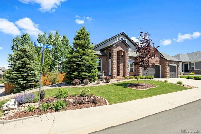 7472 Iridium Way, Castle Rock, CO 80108 - view of front of home with an attached garage, brick siding, and driveway