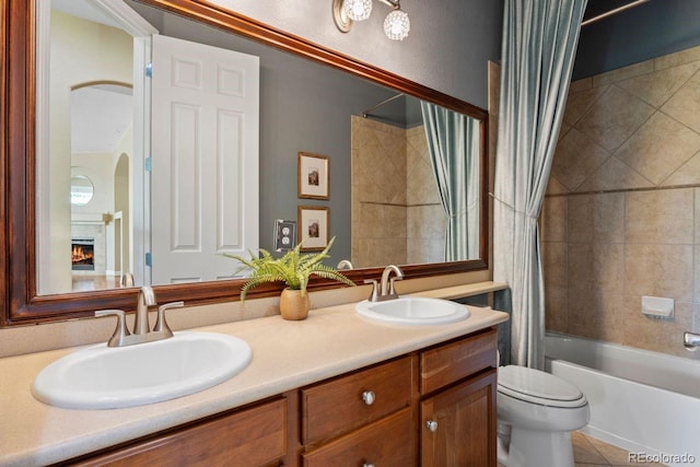 7472 Iridium Way, Castle Rock, CO 80108 - full bath with shower / bath combo with shower curtain, double vanity, a warm lit fireplace, and tile patterned floors
