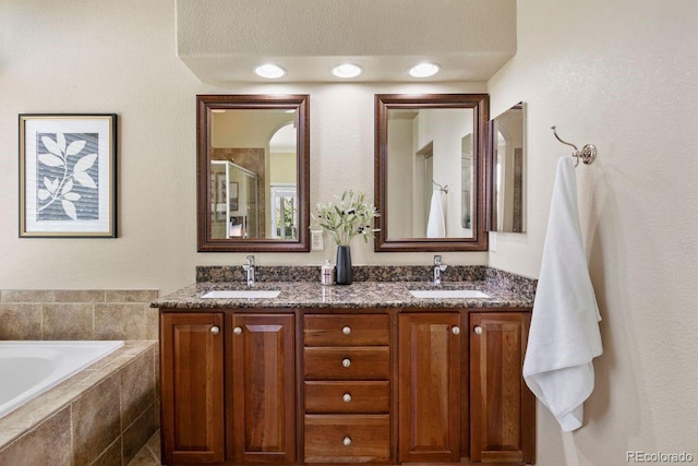 7472 Iridium Way, Castle Rock, CO 80108 - bathroom featuring a shower with door, double vanity, and a garden tub