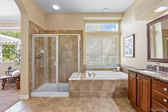 7472 Iridium Way, Castle Rock, CO 80108 - full bathroom featuring vanity, a garden tub, a stall shower, and tile patterned floors