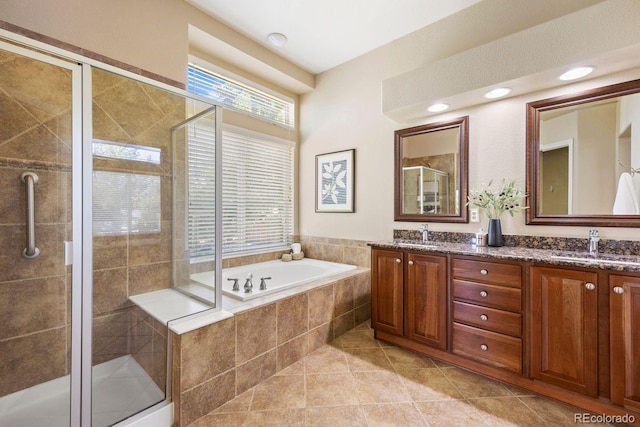 7472 Iridium Way, Castle Rock, CO 80108 - bathroom featuring a garden tub, double vanity, a shower stall, and tile patterned flooring