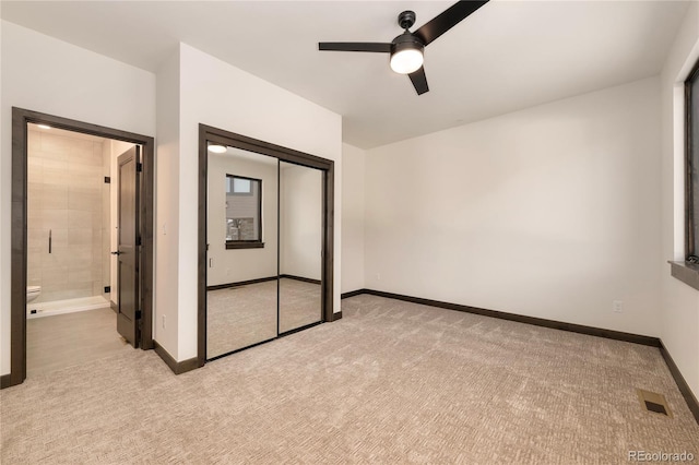 unfurnished bedroom with ceiling fan, light colored carpet, and a closet