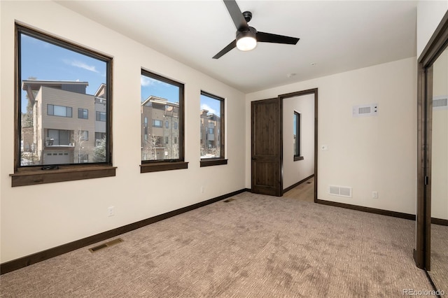 unfurnished bedroom featuring light carpet and ceiling fan