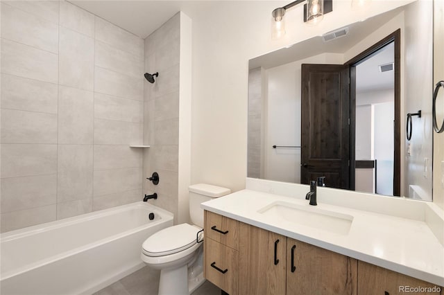 full bathroom with tiled shower / bath, vanity, and toilet