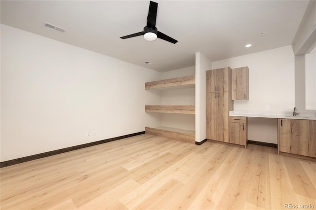 interior space featuring sink, light hardwood / wood-style floors, and ceiling fan