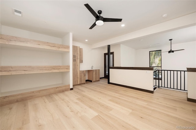 spare room featuring ceiling fan and light wood-type flooring