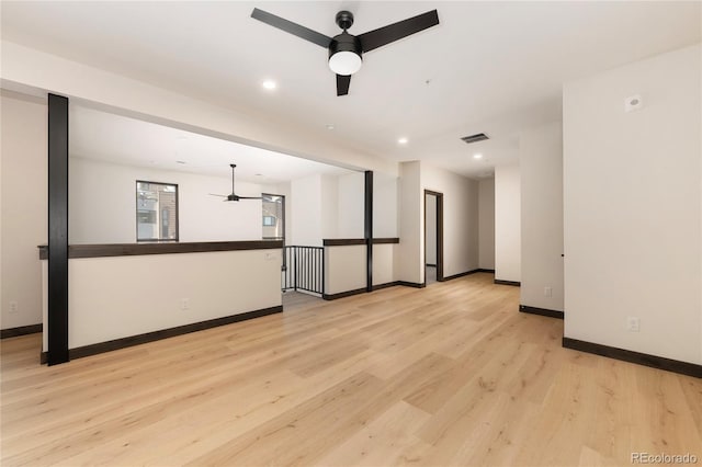 unfurnished living room featuring light hardwood / wood-style flooring and ceiling fan