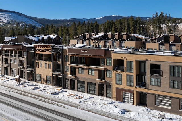 snow covered property featuring a mountain view