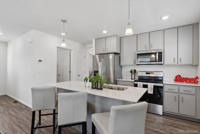 5121 N Yampa St, Denver, CO 80249 - kitchen featuring stainless steel appliances, dark wood-type flooring, light countertops, recessed lighting, and decorative light fixtures