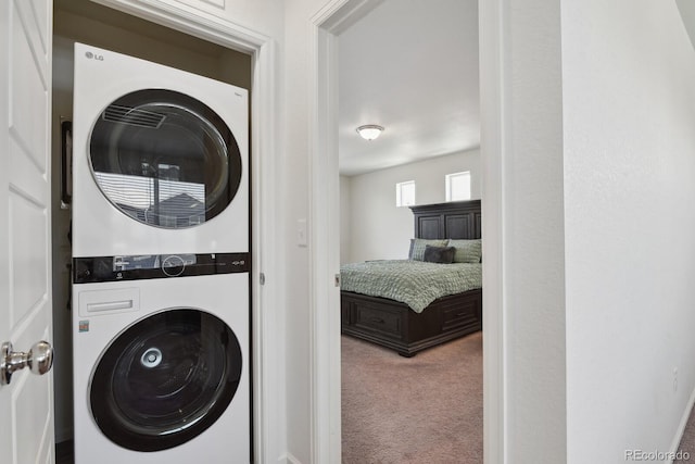 5121 N Yampa St, Denver, CO 80249 - washroom featuring stacked washer / drying machine and carpet floors