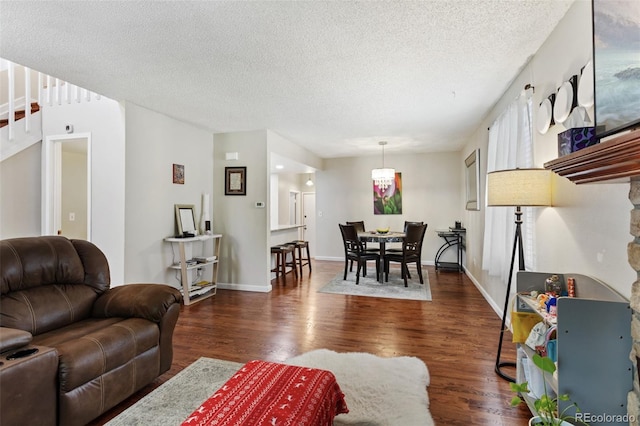 8452 Everett Way Unit C, Arvada, CO 80005 - living area with dark wood-type flooring, a textured ceiling, and stairs