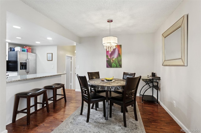 8452 Everett Way Unit C, Arvada, CO 80005 - dining area featuring dark wood-style floors, a textured ceiling, a chandelier, and recessed lighting