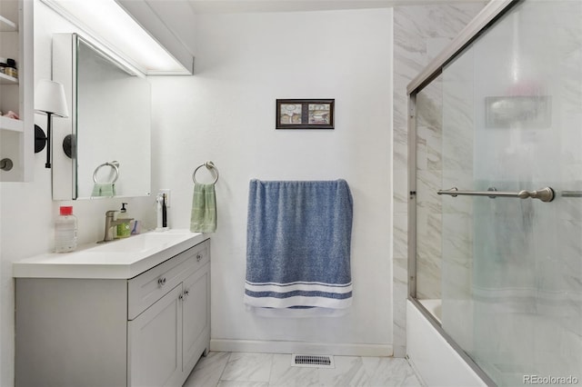 8452 Everett Way Unit C, Arvada, CO 80005 - bathroom with vanity, marble look tiles, and bath / shower combo with glass door