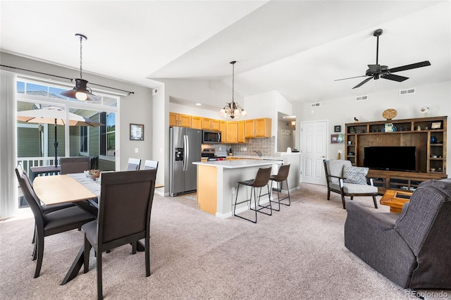 4501 Nelson Rd Unit 2201, Longmont, CO 80503 - dining space featuring vaulted ceiling, light carpet, and a ceiling fan