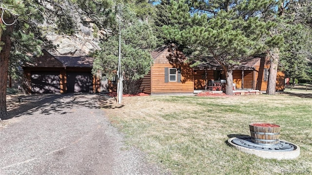 7 Rock Canyon Rd, Drake, CO 80515 - cabin featuring a garage, a front yard, a porch, driveway, and faux log siding