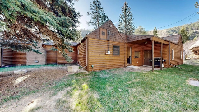 7 Rock Canyon Rd, Drake, CO 80515 - rear view of house featuring a yard and faux log siding