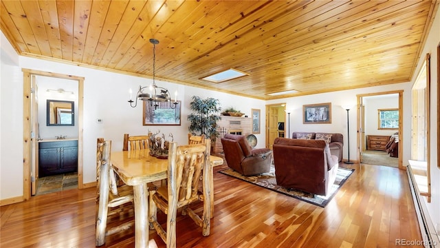 7 Rock Canyon Rd, Drake, CO 80515 - dining area featuring wooden ceiling, a chandelier, a baseboard heating unit, and light wood-style floors