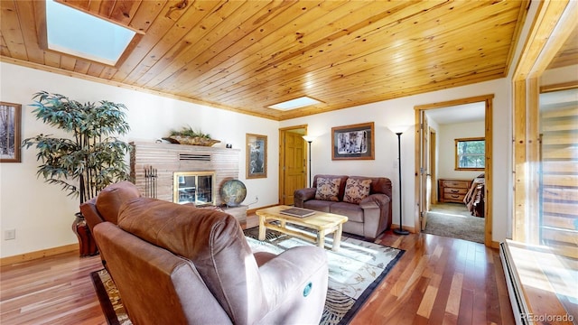 7 Rock Canyon Rd, Drake, CO 80515 - living room featuring a brick fireplace, wood ceiling, hardwood / wood-style floors, and baseboards