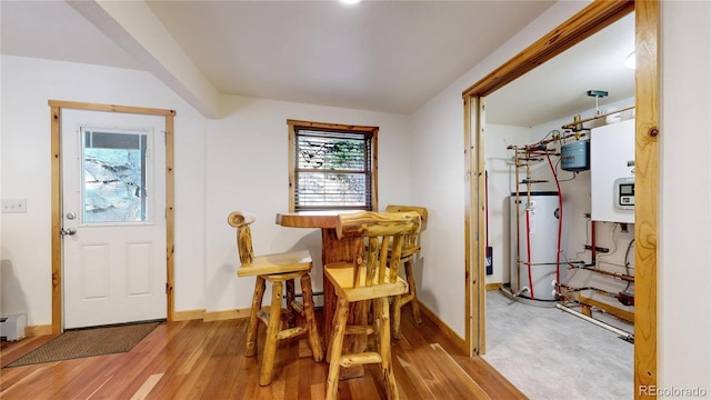 7 Rock Canyon Rd, Drake, CO 80515 - dining room with baseboards, wood finished floors, a baseboard heating unit, and gas water heater