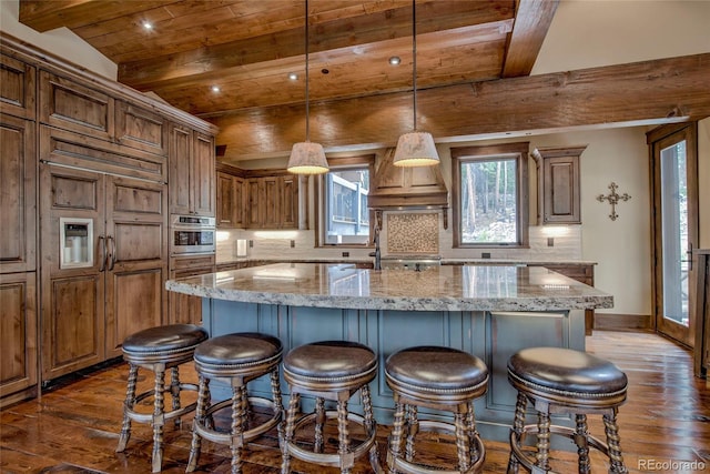 kitchen with dark wood-type flooring, beamed ceiling, wood ceiling, stainless steel oven, and decorative backsplash