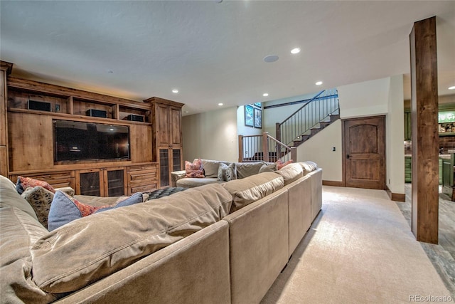 living room featuring stairway, recessed lighting, baseboards, and light carpet