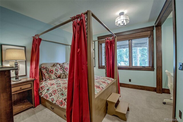 bedroom featuring baseboards and carpet