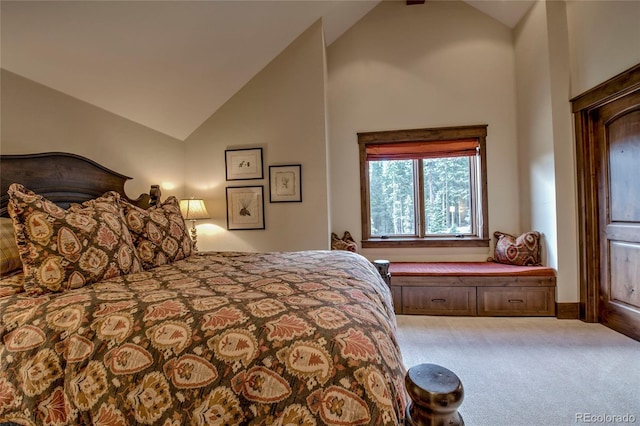 bedroom with carpet flooring and high vaulted ceiling