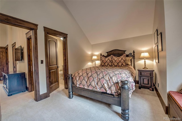 bedroom featuring light colored carpet, baseboards, and lofted ceiling